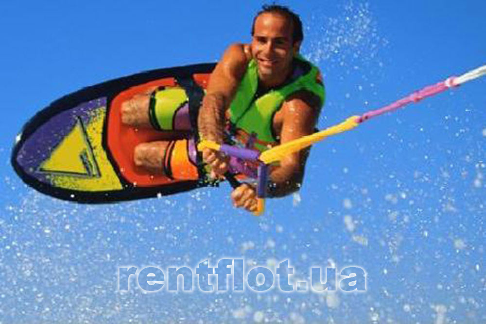 Enlarge photo on the wakeboard behind the Bombardier scooter On a wakeboard behind a Bombardier scooter