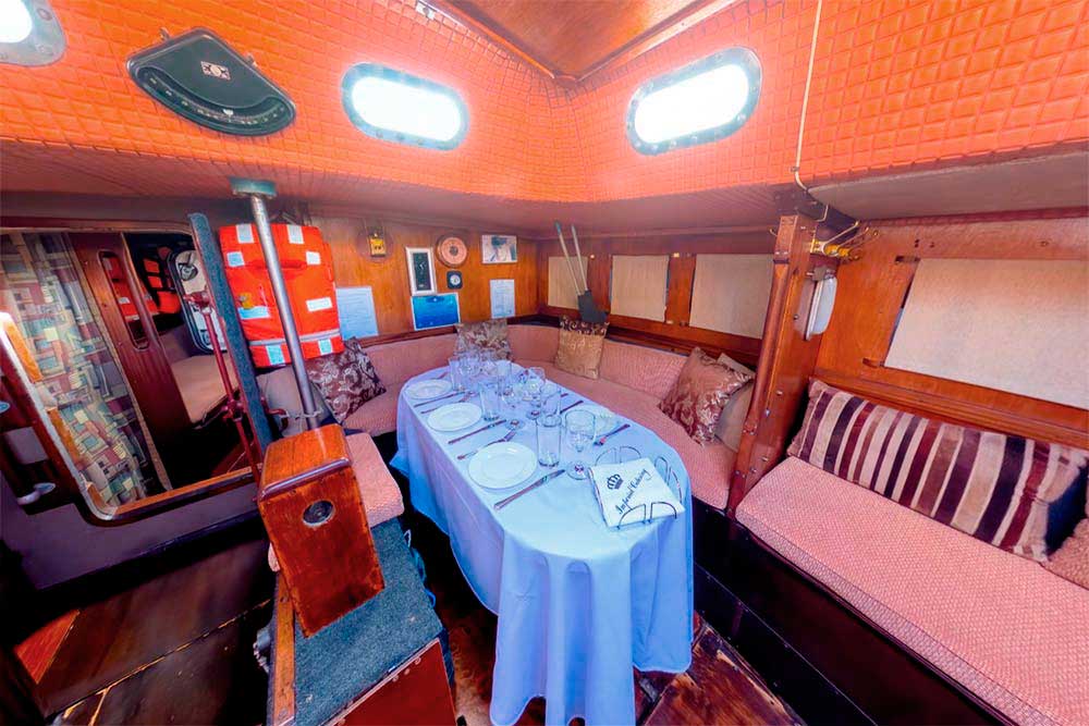 Enlarge photo of the saloon with a laid table on the sailing yacht Rif Saloon with a laid table on sailing yacht Rif