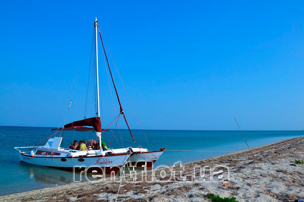 Enlarge photo of the catamaran Aladdin near the coast Catamaran Aladdin off the coast