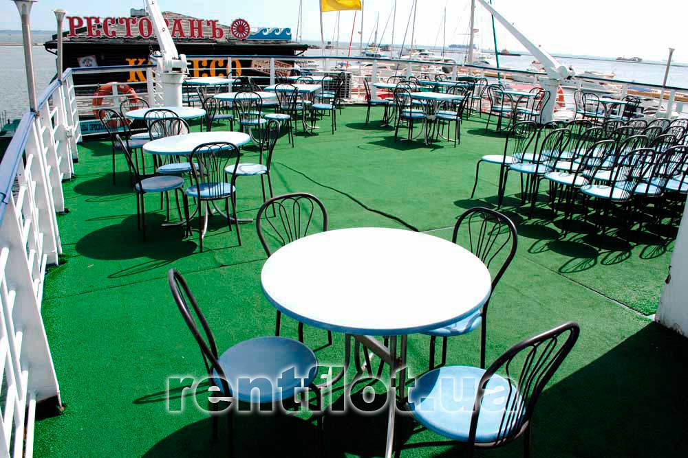Enlarge the photo of the arrangement of tables on the upper open terrace of the motor ship of the catamaran Khadzhibey Arrangement of tables on the upper open terrace of the motor ship of the catamaran Hadzhibey